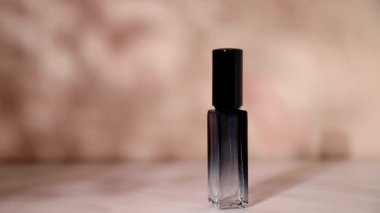 Cosmetic bottle on marble background under the shade