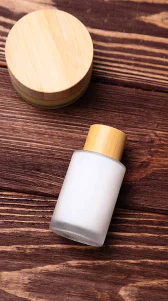 Eco cosmetics bottles mock up wooden table