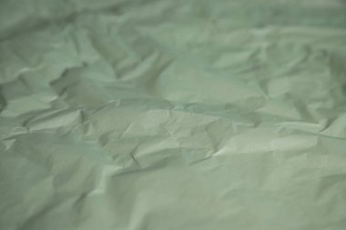 Crumpled olive color paper, blank organic sheet
