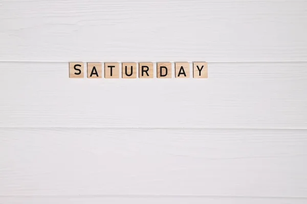 stock image Saturday week day name on white wooden background, copy space