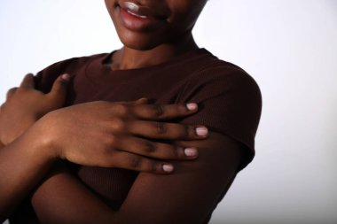 Çıplak manikür tırnakları ve vücut parçaları olan Afro kadın elleri.