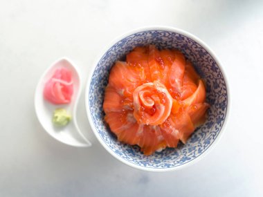 Closeup sliced salmon and salmon roe in sashimi rice bowl