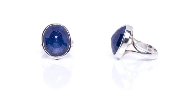 Blue Sapphire ring on white background with reflection. Collection of natural gemstones accessories. Studio shot
