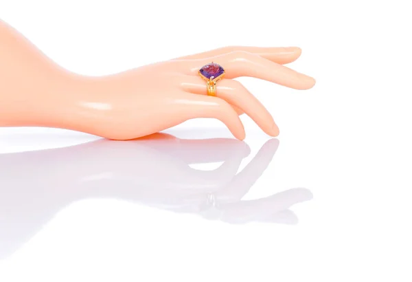 Amethyst Jewel or gems ring on plastic mannequin female hand. Collection of natural gemstones accessories. Studio shot