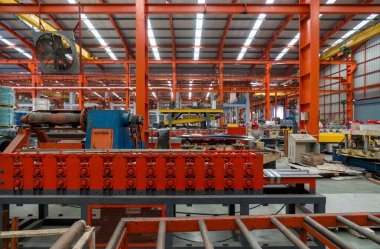 Üretim sürecinde olan sağlam bir endüstriyel makine. Geniş taşıma bandı çalışma alanında..