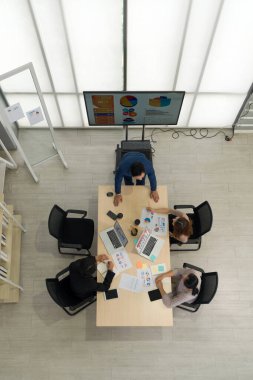 Modern ofiste bilgisayar, tablet, cep telefonu ve kahveyle modern ofis yöneticileri toplantısı. Kurumsal iş adamları konsepti. Üst Görünüm