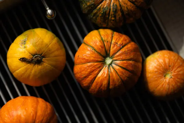 Pumpkins on the grill. Autumn harvest. Selective focus.
