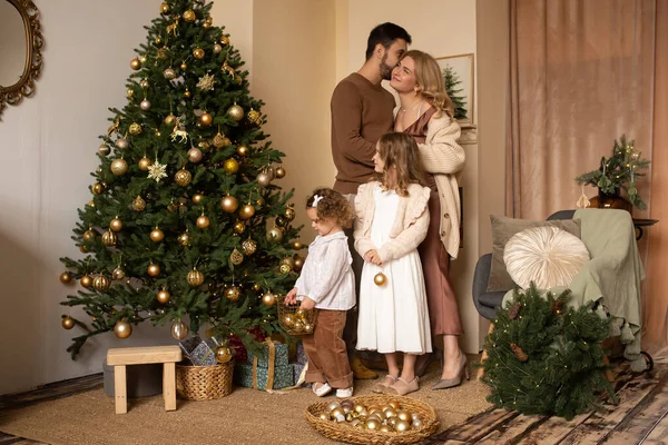 happy family in their living room, in front of the Christmas tree