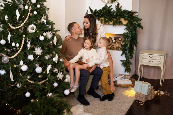 happy family in their living room, in front of the Christmas tree