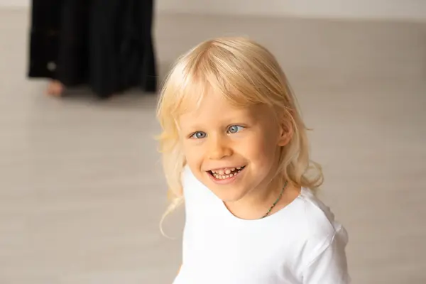 stock image Little boy with strabismus eyes, squinting eyes. Child boy wearing white t-shirt at home