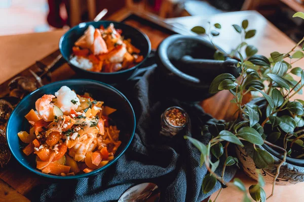2 bowls on a tray with Thai Cuisine