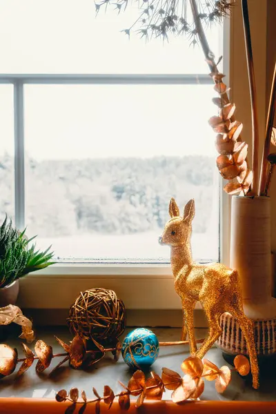 Cerf Doré Boules Noël Sur Rebord Fenêtre Avec Vue Sur Image En Vente