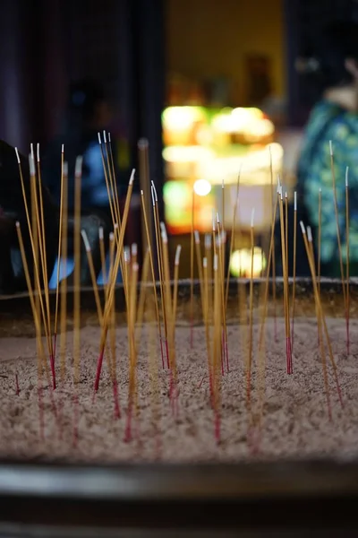 Focus and blurred the many incense sticks are lit and placed in an incense burner.