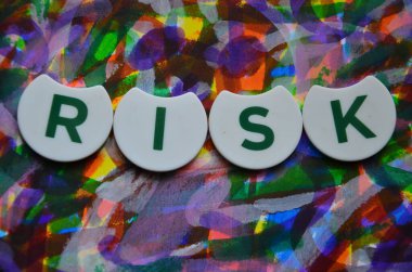 Soyut renkli arkaplanda risk sözcüğü