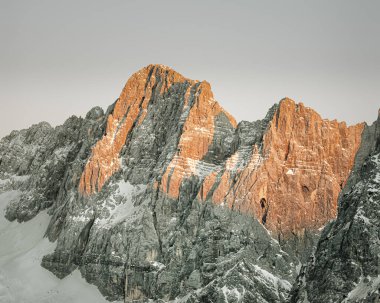 Sloveina, Vrisic Pass - January 2022: Red sunset or alpen glow reflecting off the Julien alps clipart