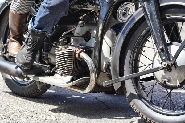 stock image Man and woman leather boots on the vintage motorcycle, closeup detail