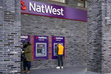 Londra, Birleşik Krallık - 2 Şubat 2019: İnsanlar Natwest ATM 'sinden para çekiyor. Ulusal Westminster Bankası, İngiltere 'deki dört büyük bankadan biri olarak kabul edilir ve 1968 yılında kurulmuştur.