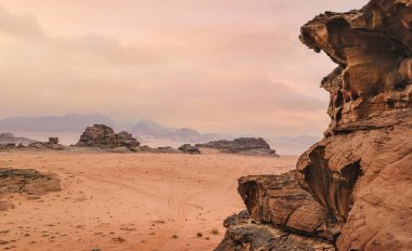 Kırmızı turuncu Mars, Ürdün Wadi Rum Çölü 'ndeki manzara gibi. Dağların arka planı, bulutlu bir sabah. Bu konum birçok bilim kurgu filminde kullanılmıştır..