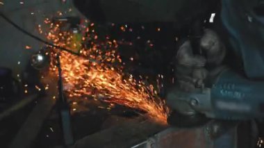 Çalıştığım atölyedeki metal araba parçası, yakın çekim detayı, etrafta uçuşan turuncu kıvılcımlar...