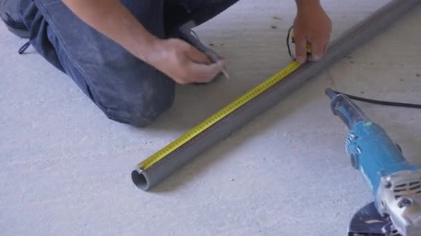 Construction Worker Measuring Plastic Tube Cables Yellow Tape Measure Concrete — Stock Video