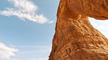 Looking up the Elephant Rock or Jabal AlFil formation in Al Ula, Saudi Arabia, sunny sky above. It is popular tourist spot in AlUla