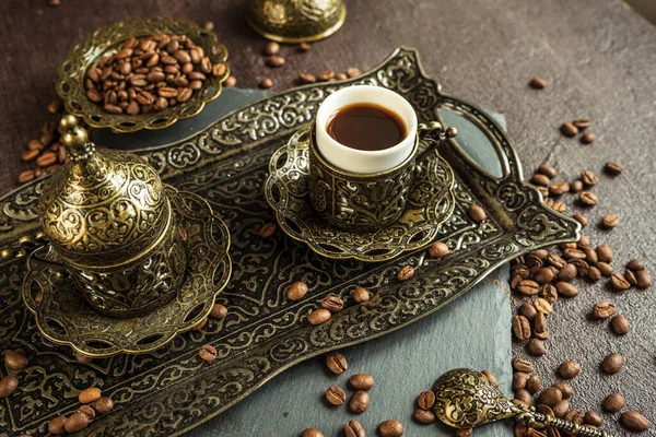 traditional turkish coffee in vintage cup in metal service, anise, roasted beans on brown background 2