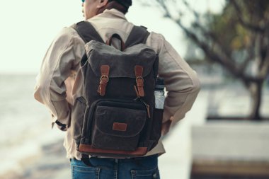 Turistler gün batımını izlemek için ayakta duruyorlar. Sırt çantası, seyahat kavramı