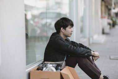 Çalışanlar şirketten kovuldu ya da istifa etti. Stresli oturuyorlar, şirketin önünde cesaretleri kırılıyor.