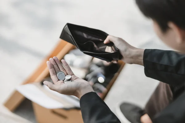 stock image Employees fired or resigned from the company are opening their wallets and holding coins in their hands