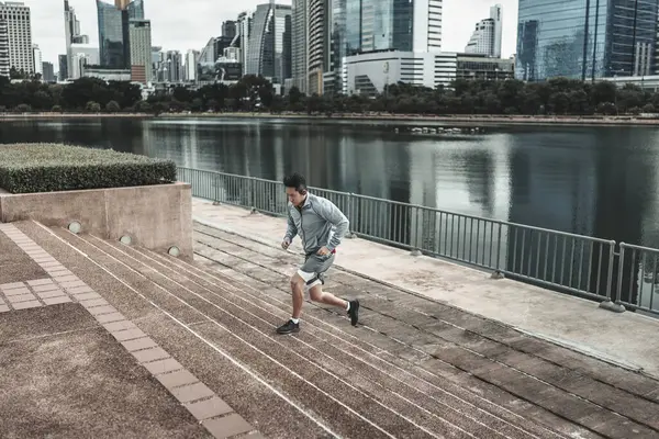 stock image A man  running up on stairs in the city center park for cardio workout.  Health and Lifestyle in big city life concept.