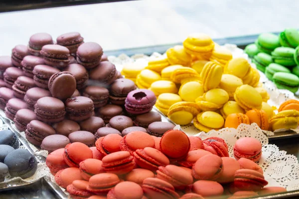 Colorful macarons on display in a shop window. Colorful macarons in showcase, patisserie, and sweet shop.