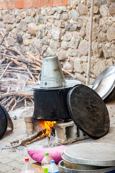 stock image Traditional pot for cooking food on the fire in the village. Cooking soup in a cauldron on the fire in the village