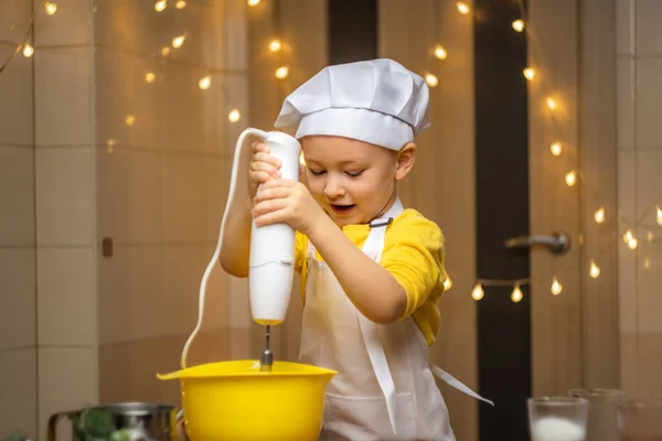 Boy helping mom prepare pie dough with mixer whisk. High quality 4k footage