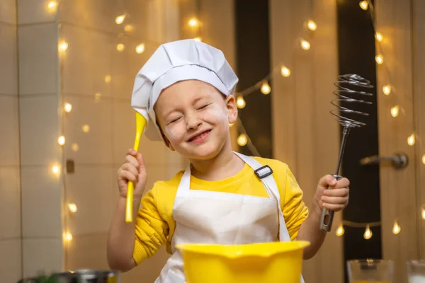 Boy think about future baking, cooking in kitchen, wearing apron and caps for cooking. High quality 4k footage