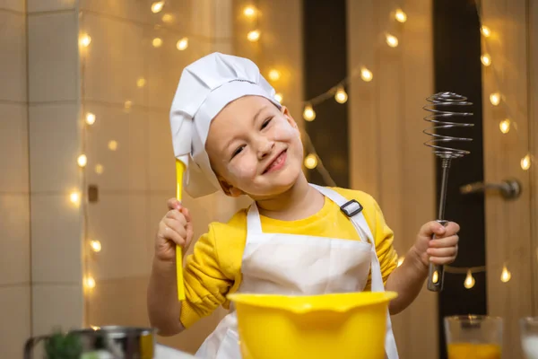 Boy think about future baking, cooking in kitchen, wearing apron and caps for cooking. High quality 4k footage
