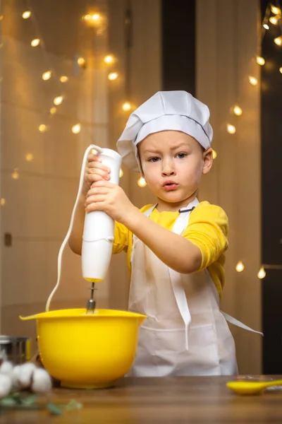 Boy helping mom prepare pie dough with mixer whisk. High quality 4k footage