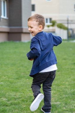 Güneşli bir günde bahçede koşan çocuk, çocuk ve sağlıklı yaşam tarzı. Yüksek kalite fotoğraf