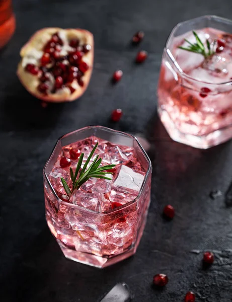 stock image Healthy pomegranate juice with ice in a glass on a dark vintage background close up 