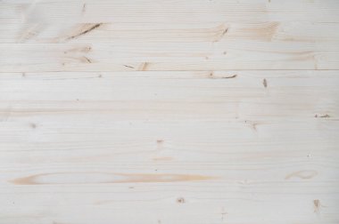Hafif ahşap arkaplan. Tahta masanın en üst manzarası. Düğümlenmiş ahşabın açık yüzeyi ve kopyalama alanı ile doğal rengi