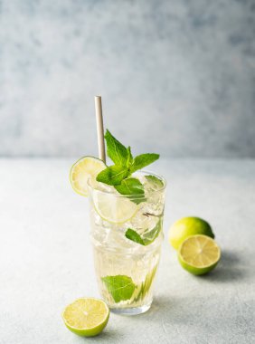 Limonlu, naneli ve buzlu uzun bardakta mojito kokteyli. Turunçgil meyveleriyle ferahlatıcı limonata içeceği konsepti. Boşluğu kopyala. 