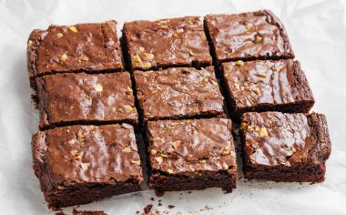 Çikolatalı kek ve fındıklı kek yakın çekim kağıdında dilimlenmiş. Ev yapımı sağlıklı vejetaryen pişirme konsepti. 