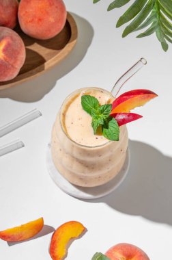 Sıcak, aydınlık bir odada elinde limonlu ve otlu çay tutan bir kadın. Kahvaltı ve sağlıklı beslenme konsepti. Boşluğu kopyala.