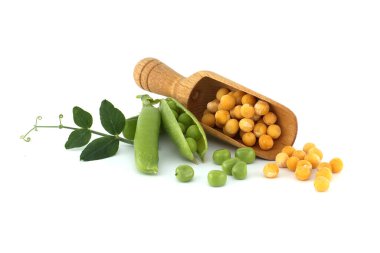 Taze yeşil bezelyeler ve yeşil yapraklı bezelye kabukları yanında ahşap kepçeyle kurutulmuş bezelyeler beyaz arka planda izole edilmiş.