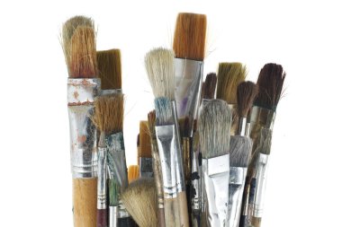 Assortment of various types and sizes of paintbrushes isolated on white background clipart