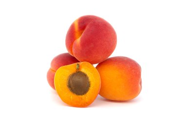 Pile of ripe apricots and one sliced in half to showcase its succulent interior, isolated on a white background clipart