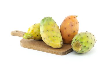 Colorful prickly pears displayed on a wooden cutting board. The image highlights their vibrant colors and unique textures against a white background