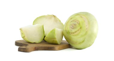 Bütün bir yabacı ve dilimlenmiş parçaları beyaz bir arka plana karşı tahta bir kesme tahtasına yerleştirilmiş..