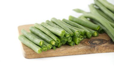 Freshly prepared green beans displayed on wooden chopping board ideal for healthy recipes salads or vegetarian meals. Perfect ingredient concept for natural and nutritious food photography enthusiasts clipart