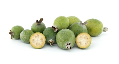 Taze feijoa meyvelerinin yarı yarıya kesilmesi, doku ve tohumlarının sergilenmesi, sade beyaz arka planda sergileniyor.