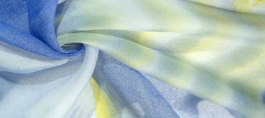 Yumuşak mavi, soyut desenleri ve yatak tonları olan ipek kumaş, sarı ve beyaz tonlarda. Doku, desen, koleksiyon